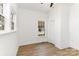 Bright bedroom featuring a hardwood floor, a classic ceiling fan and two windows at 1712 S Main St, Salisbury, NC 28144