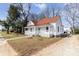 Newly renovated home with a white exterior, red roof, and spacious front yard at 1712 S Main St, Salisbury, NC 28144