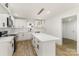 Well-lit kitchen equipped with white cabinets, marble backsplash, stainless appliances, and a kitchen island at 1712 S Main St, Salisbury, NC 28144