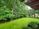 Expansive backyard with lush greenery and a view of a wooden fence, offering a peaceful retreat at 172 Foxtail Dr, Mooresville, NC 28117