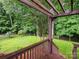 Inviting backyard view from the deck with a wood pergola and a lush lawn surrounded by mature trees at 172 Foxtail Dr, Mooresville, NC 28117
