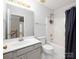 Bright bathroom features a single sink vanity, toilet, and shower-tub combination with shower curtain at 172 Foxtail Dr, Mooresville, NC 28117