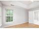 Bright bedroom with wood-look floors, a ceiling fan, and an ensuite bathroom at 172 Foxtail Dr, Mooresville, NC 28117