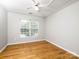 Bedroom features wood-look flooring, large windows with blinds and a ceiling fan at 172 Foxtail Dr, Mooresville, NC 28117