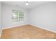 Bedroom features wood-look flooring, large windows with blinds and a ceiling fan at 172 Foxtail Dr, Mooresville, NC 28117