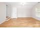 Bonus room with wood-look flooring, a ceiling fan, and natural light from the window at 172 Foxtail Dr, Mooresville, NC 28117