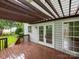 Back deck of home with wood floors, dark wood pergola and view of the treed backyard at 172 Foxtail Dr, Mooresville, NC 28117