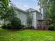 Charming two-story home exterior featuring a backyard deck with pergola, well-maintained lawn, and mature trees at 172 Foxtail Dr, Mooresville, NC 28117
