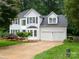 Charming two-story home with a manicured lawn, two-car garage, and beautiful landscaping at 172 Foxtail Dr, Mooresville, NC 28117