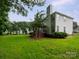 Well-maintained home exterior with a spacious backyard, deck with pergola, and mature landscaping at 172 Foxtail Dr, Mooresville, NC 28117
