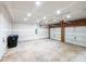 Unfinished two car garage with automatic door openers, primed drywall and concrete flooring at 172 Foxtail Dr, Mooresville, NC 28117