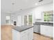 Bright kitchen boasts an island with granite countertops, stainless steel dishwasher, and a view of the outdoor patio at 172 Foxtail Dr, Mooresville, NC 28117