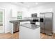 Bright kitchen featuring stainless steel appliances, granite countertops, and a center island at 172 Foxtail Dr, Mooresville, NC 28117