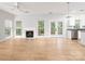 Spacious living room features a cozy fireplace, natural light from large windows, and hardwood floors at 172 Foxtail Dr, Mooresville, NC 28117