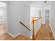 Staircase with wood handrail and white spindles leads to the upper level at 172 Foxtail Dr, Mooresville, NC 28117