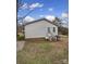 Rear view of a ranch home with brick foundation and small deck at 1955 Gilmore Rd, Rock Hill, SC 29730