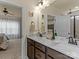 Bathroom featuring double sinks, marble counters, dark wood cabinets, with view into bedroom and shower at 200 Staffordshire Dr, Statesville, NC 28625