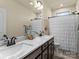 Elegant bathroom featuring a double vanity with a marble countertop, dark cabinets, and decorative mirrors at 200 Staffordshire Dr, Statesville, NC 28625