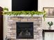 Elegant stone fireplace with a mantel decorated with greenery and decorative accents at 200 Staffordshire Dr, Statesville, NC 28625