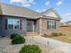 Inviting entryway featuring stone accents, landscaped walkway, and stylish front door at 200 Staffordshire Dr, Statesville, NC 28625