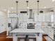 Modern kitchen featuring white cabinetry, stainless steel appliances, and a marble-top island with seating at 200 Staffordshire Dr, Statesville, NC 28625