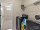 Convenient laundry room featuring modern washer and dryer with shelving for storage at 200 Staffordshire Dr, Statesville, NC 28625