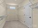 Spacious walk-in closet with multiple shelves, carpeted floors and natural light from a small window at 200 Staffordshire Dr, Statesville, NC 28625