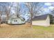 View of the home's backyard, detached garage, and yard at 202 W Main St, Cherryville, NC 28021