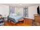 Cozy bedroom with hardwood floors, large bed and ample closet space at 202 W Main St, Cherryville, NC 28021