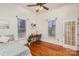 Comfortable bedroom with hardwood floors, ceiling fan and French doors at 202 W Main St, Cherryville, NC 28021