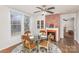 Dining area with hardwood floors, fireplace and glass-top table at 202 W Main St, Cherryville, NC 28021