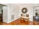 Bright entryway with a bench, baskets, and sunburst mirror at 202 W Main St, Cherryville, NC 28021