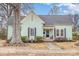 Quaint light green house with front porch and mature trees at 202 W Main St, Cherryville, NC 28021