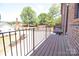 Balcony with wood-like floor and black metal railings offering views of the yard with mature trees at 216 Gilead Rd, Huntersville, NC 28078