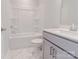 Bathroom with a shower-tub combo, white subway tile, marble floors, and white cabinets at 216 Gilead Rd, Huntersville, NC 28078
