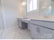 Bathroom featuring a double vanity with gray cabinetry and marble tile flooring at 216 Gilead Rd, Huntersville, NC 28078