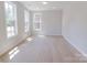 Spacious bedroom with large windows, light wood grain floors, and natural light at 216 Gilead Rd, Huntersville, NC 28078
