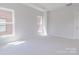 Bright bedroom with neutral walls, carpet, and lots of light streaming from large windows at 216 Gilead Rd, Huntersville, NC 28078