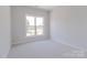 Neutral bedroom featuring a large window allowing for natural light and views at 216 Gilead Rd, Huntersville, NC 28078