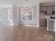 Dining room with modern chandelier fixture, and windows facing exposed brick at 216 Gilead Rd, Huntersville, NC 28078