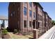 Brick townhomes with black-framed windows and black doors, surrounded by a low wrought iron fence at 216 Gilead Rd, Huntersville, NC 28078