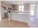 Modern kitchen featuring gray cabinets, stainless steel appliances, white subway tile backsplash, and a large center island at 216 Gilead Rd, Huntersville, NC 28078