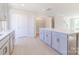 Open kitchen with an island, granite countertops, stainless appliances and a door to a pantry and another one to the garage at 216 Gilead Rd, Huntersville, NC 28078