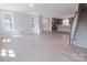 Spacious living area featuring lots of natural light and a glimpse of the kitchen with light gray cabinetry at 216 Gilead Rd, Huntersville, NC 28078