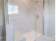Bathroom shower featuring marble-patterned tile, glass door and a built in bench at 216 Gilead Rd, Huntersville, NC 28078