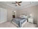 A well-lit bedroom featuring a ceiling fan and a view into the en-suite bathroom at 250 Cherry Tree Dr, Fort Mill, SC 29715