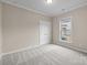 Neutral bedroom with plush carpet, large closet doors, and bright window at 250 Cherry Tree Dr, Fort Mill, SC 29715