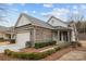 Charming home featuring a two-car garage, stone accents, and a covered front porch at 250 Cherry Tree Dr, Fort Mill, SC 29715