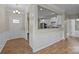 Bright open kitchen with white cabinetry, granite counters, stainless steel appliances, and hardwood floors at 250 Cherry Tree Dr, Fort Mill, SC 29715