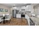 Bright open kitchen with white cabinetry, stainless steel appliances, granite counters, and a dining area at 250 Cherry Tree Dr, Fort Mill, SC 29715